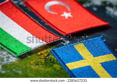 The flags of Turkey and Hungary in front of the symbol of Sweden. The concept of mutual relations between states, Political situation, Negotiations on Sweden's accession to a defense alliance