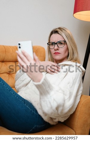 Shocked concerned cellphone user girl staring at screen, looking at smartphone screen, finding problems with online app, poor connection, Internet service, getting surprising bad news
 Royalty-Free Stock Photo #2285629957