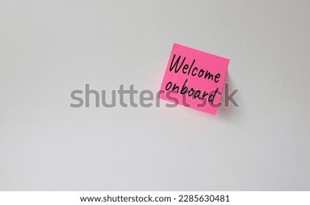 Welcome onboard symbol. Concept words Welcome onboard on pink steaky note. Beautiful white background. Business and Welcome onboard concept. Copy space.