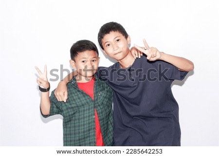 portrait two asian child boy together, isolated white background