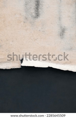 Old grunge torn collage urban street posters creased crumpled paper placard texture background. Ripped faded paper backdrop surface placard