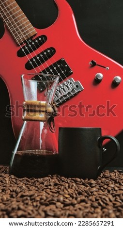 A coffee brewing jug, a red electric guitar, a black coffee mug and coffee beans on  black background. Vintage music and coffee concept.