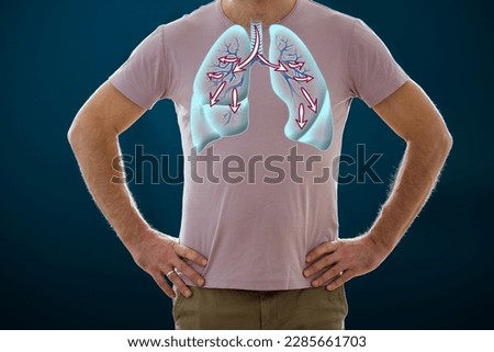 The man standing on a dark background. Picture of a human lungs. Anatomy of healthy respiratory system. Breathing exercises, inhaling. Medical concept, internal organs