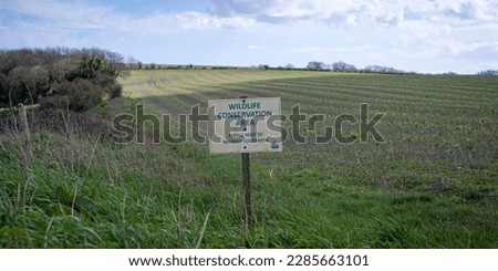 Wildlife conservation area sign by a field in the Sussex countryside Royalty-Free Stock Photo #2285663101