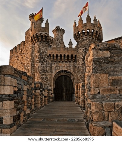 spanish and castile flag over the Ponferrada castle in spain with the entrey door Royalty-Free Stock Photo #2285668395