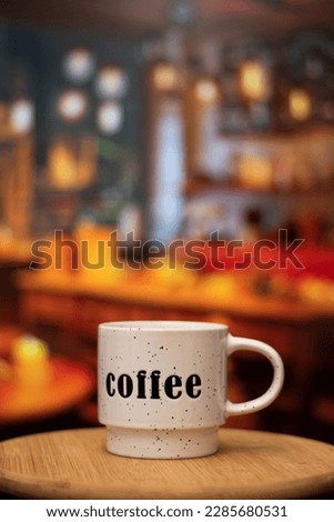 Vertical close up of a cup of Coffee in a bakery restaurant vintage with bokeh background Royalty-Free Stock Photo #2285680531