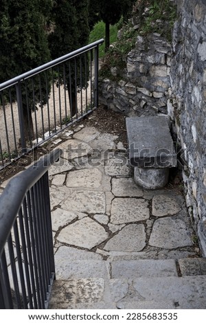 Stone  bench on a stone staircase in a park