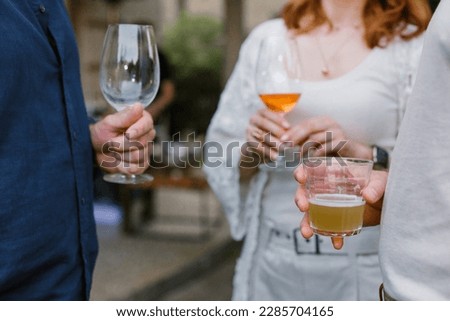 People holding glasses with alcohol wine and beer
