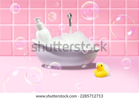 Mini bath with foam and soap bubbles on a pink background with tiles and a yellow duck.