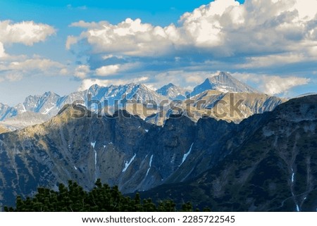 View of the peaks of the High Tatras from the Kondracka Pass. A beautiful play of light and shadows on the slopes of the mountain.