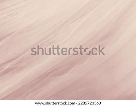 Pale pink textured voile fabric background with space for copy