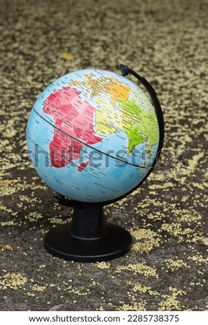 earth globe on a beige textured background showing continent Africa, Europe and Middle East
