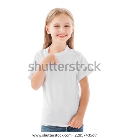 Smiling little girl showing white blank t-shirt isolated on a white background Royalty-Free Stock Photo #2285743569