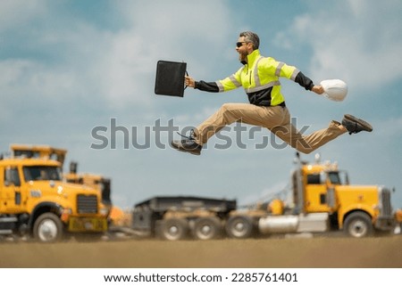 Hispanic 40 s builder excited jump on site construction. American middle aged man builder. Millennial construction builder near at building. Portrait of builder worker man near construction building. Royalty-Free Stock Photo #2285761401