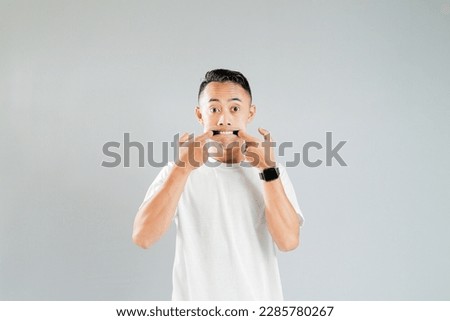 an asian youth showing a ridiculous expression
