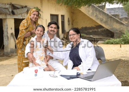 Portrait of an Indian doctor and villagers at village