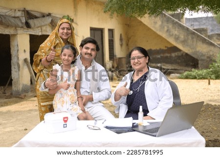 Portrait of an Indian doctor and villagers at village