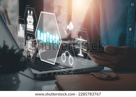 RegTech, Regulation Compliance financial control modern internet technology concept, Person working on laptop computer with RegTech icon on virtual screen. 
