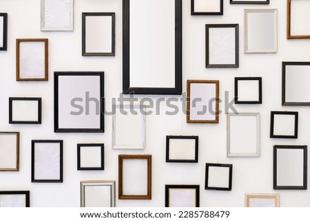 Many empty picture frames on the white wall, home decoration