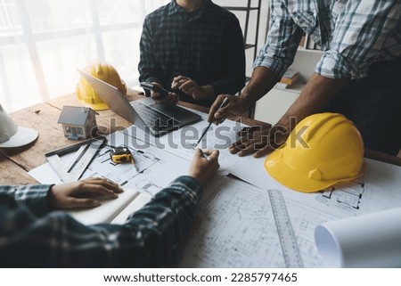 Architectural engineer team meeting Drawing and calculations for architectural structures and engineering tools in the workplace. Structural and technical construction concepts. Royalty-Free Stock Photo #2285797465