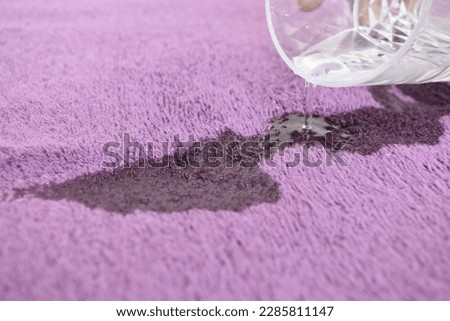 Spilling And Pouring Water On The Purple Water Highly Observation Quick Drying 100% Cotton Bath Towel Focus Capture Towel Glass Water. Dropping Water on The Purple Bath Towel Royalty-Free Stock Photo #2285811147