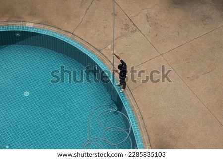 The swimming pool is cleaned professionally and expertly Royalty-Free Stock Photo #2285835103