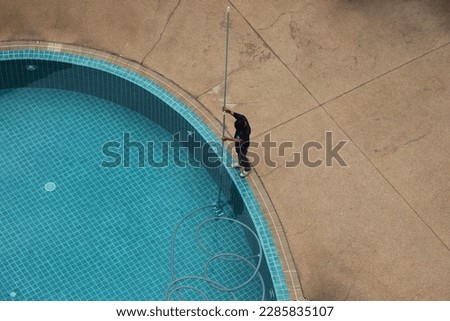 The swimming pool is cleaned professionally and expertly Royalty-Free Stock Photo #2285835107