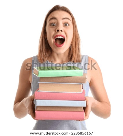 Surprised young woman with books on white background