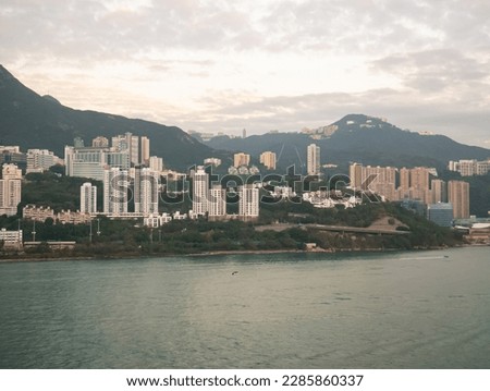 View of Hong Kong Island living quarter cityscape with many skyscraper buildings from sea.