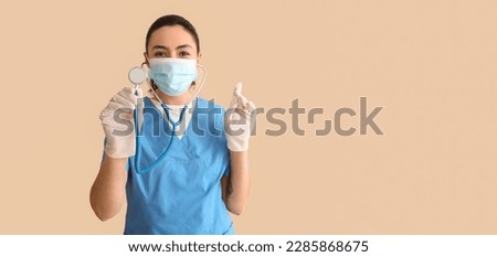 Female medical assistant with stethoscope on beige background with space for text