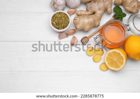Different natural cold remedies on white wooden table, flat lay with space for text. Cough treatment Royalty-Free Stock Photo #2285878775