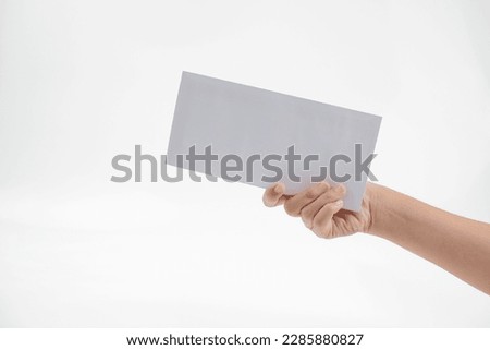 a woman's hand hands over a white envelope
 Royalty-Free Stock Photo #2285880827
