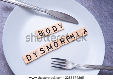 flat lay photo showing the word body dysmorphia on a plate. BDD is a mental disorder Royalty-Free Stock Photo #2285894265