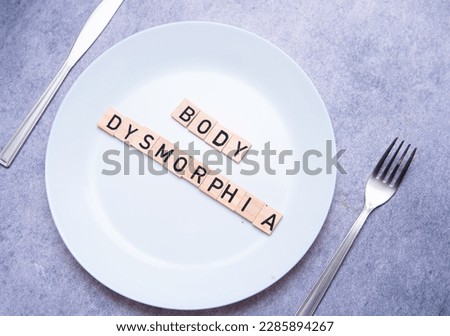 flat lay photo showing the word body dysmorphia on a plate. BDD is a mental disorder Royalty-Free Stock Photo #2285894267