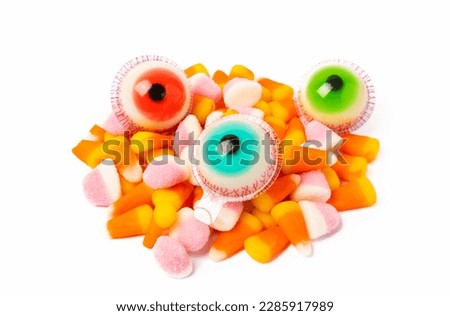 Halloween candy jelly eye, pumpkin marshmallows, corn candy isolated on white background.Classic candy sweets for Halloween with.Halloween holiday concept with candy corn and jack o lantern.