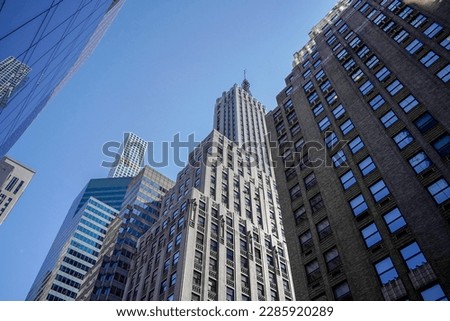 new york city manhattan skyscrapers view from the street to the top of the building on sunny clear day