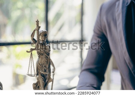 Lawyer working in the office law and justice concept male judge Businessman's consultant legal service Advising on various contracts to plan a case in court.