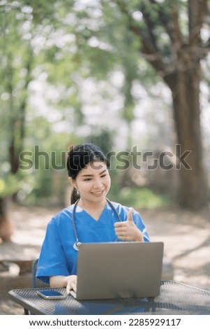 Doctor working on laptop computer on clipboard on desk, electronics medical record system EMRs concept.