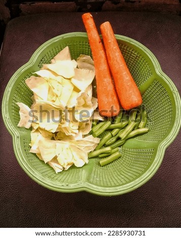 Photo of sliced ​​vegetables, in a green plastic basket. organic, fresh and healthy food.
