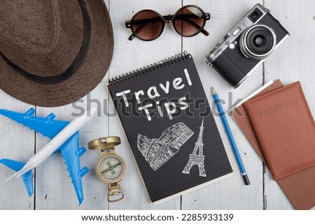 Travel Tips concept sketch , Airline tickets, passport, sunglasses and camera on wooden desk Royalty-Free Stock Photo #2285933139