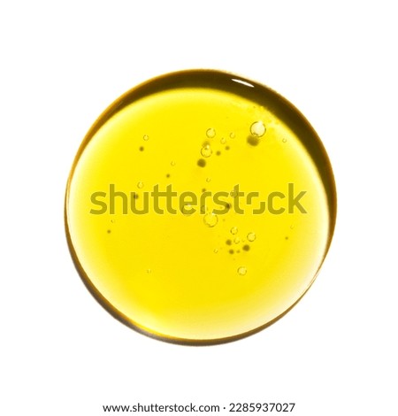 Drop of yellow oil swatch texture in petri dish macro with bubbles, cosmetics for face and body, science, laboratory isolated on white background Royalty-Free Stock Photo #2285937027