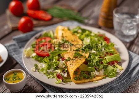 Delicious eggs omelette with salad and vegetable