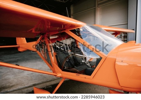 Photo of a small orange airplane for 2 people details