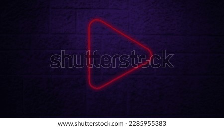Image of red neon arrow icon on brick background. Social media and digital interface concept digitally generated image.