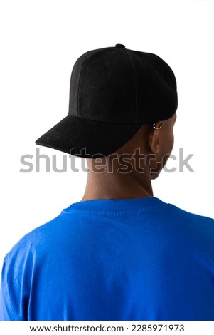 African american man wearing blue t-shirt and black cap with copy space on white background. Clothes, fashion, style and design.