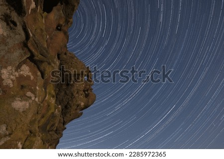 A beautiful star trail photograph taken at The Winking Man, a natural rock formation found at Ramshaw Rocks on Blackshaw moor in The Peak District National Park England.