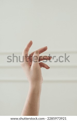 woman hand in front of white wall soft interior 