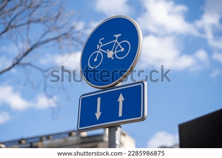 Blue color bike path sign on the street.