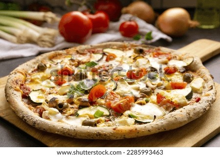 Fresh  homemade vegetarian Pizza, healthy pizza crust with wholemeal flour, sesame and linseeds, topping with vegetables, mozzarella, hollandaise sauce and cashew nuts Royalty-Free Stock Photo #2285993463