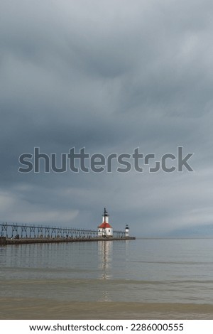 Storm clouds approaching St. Joseph lighthouse and beach.  St. Joseph, Michigan, USA. Royalty-Free Stock Photo #2286000555